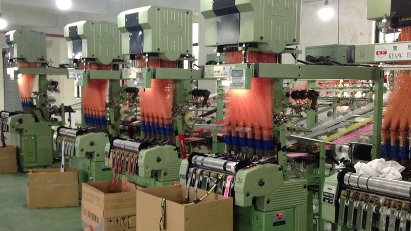 Cost comparison infographic showing how rush production and air freight increase total landed cost for lanyard orders.