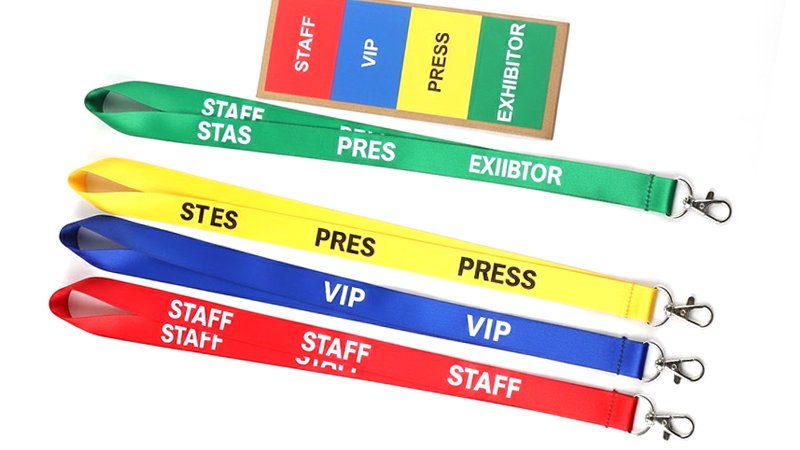 Color-coded lanyards with role labels for trade show staff, VIP, press, and exhibitors