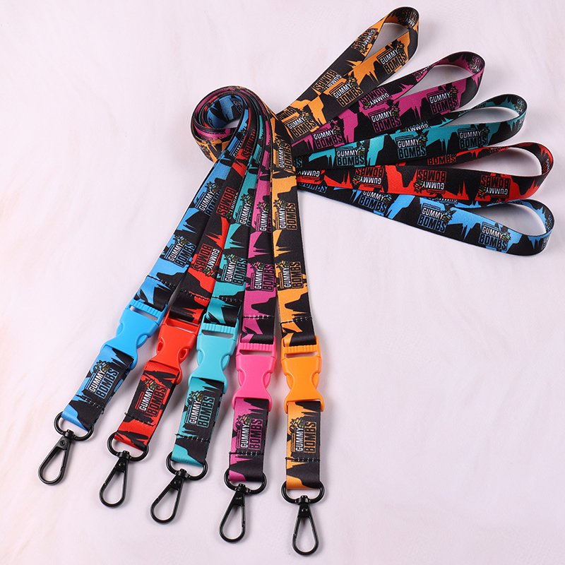 Custom printed lanyards with colorful breakaway buckles and black swivel hooks, featuring bold graphic patterns.