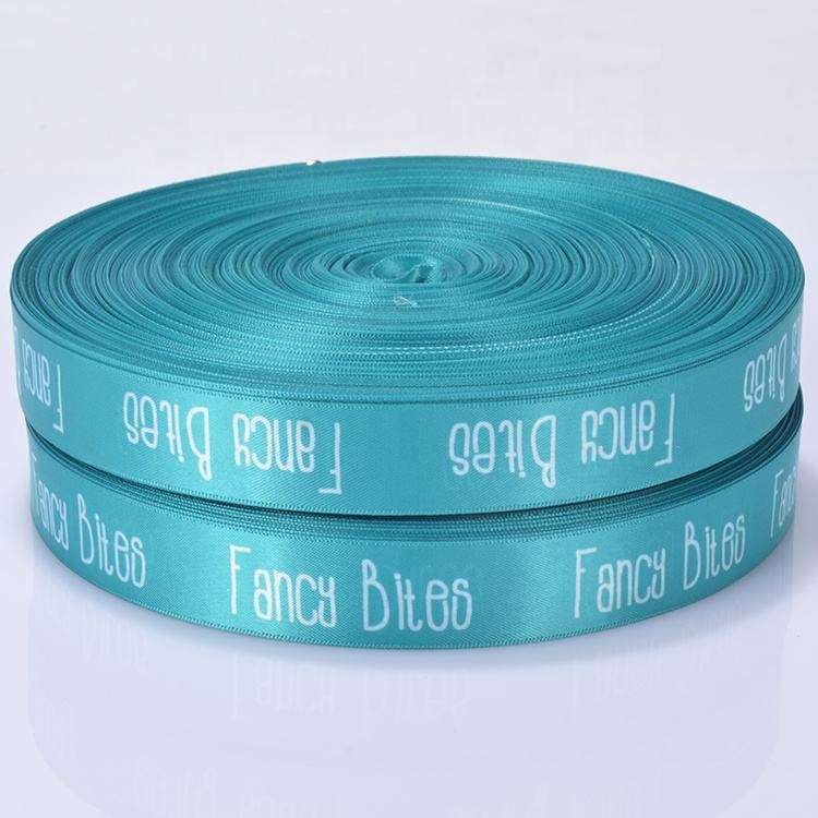 Screen printed polyester webbing with repeating logo pattern, high-quality woven strap material