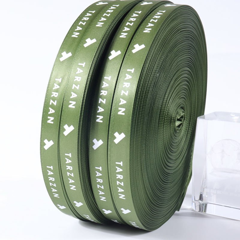 Screen printed polyester webbing with repeating logo pattern, high-quality woven strap material