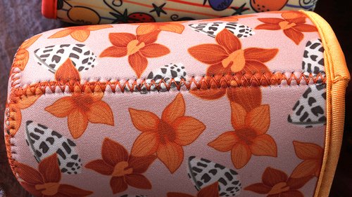 Reinforced side seam stitching on a custom printed neoprene coffee sleeve