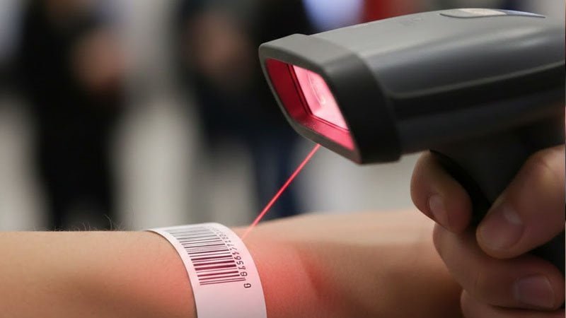 Barcode wristband scanned with a handheld scanner for simple identification and check-in.