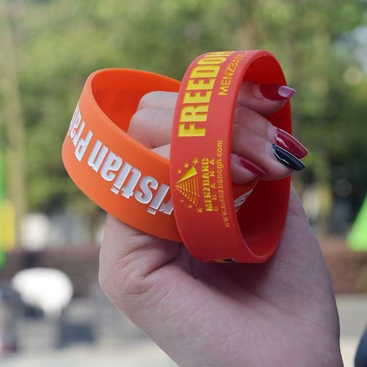 People wearing custom silicone wristbands and bracelets at a promotional event