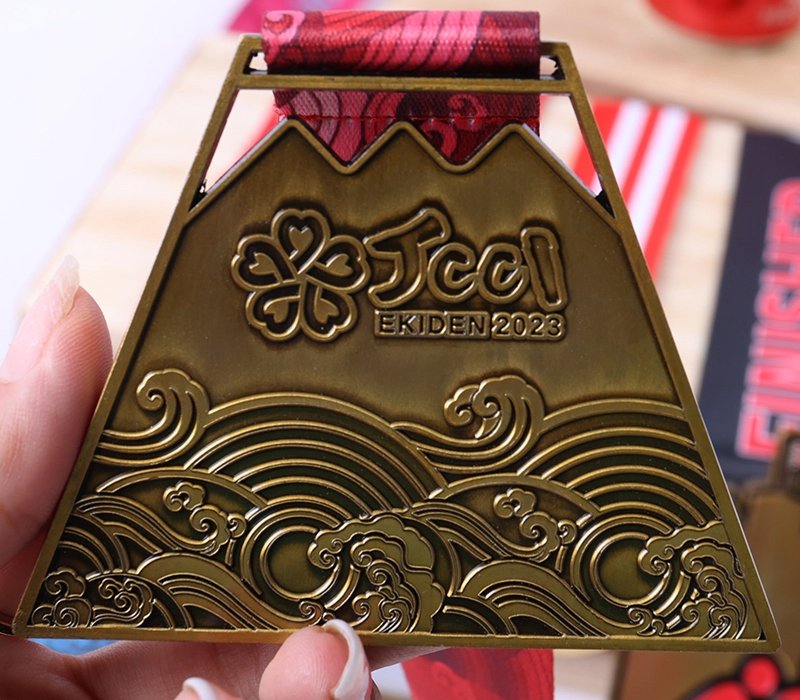 Antique finish metal medals with vintage bronze and silver tones, highlighting engraved details.