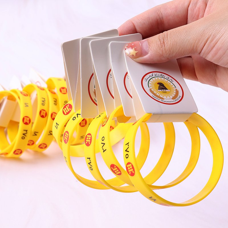 Promotional silicone wristbands with personalized printing, including product hang tags for added presentation
