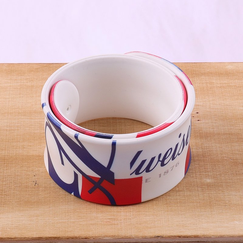 custom printed slap wristband wrapped around wrist showing snap-on function