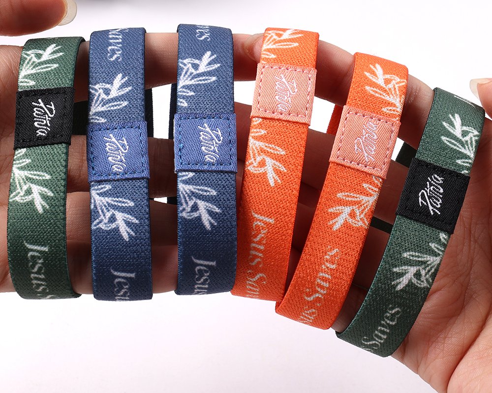 Custom elastic wristbands with full color sublimation printing and woven labels