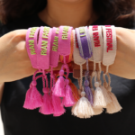 premium embroidered wristbands with custom text and tassel design