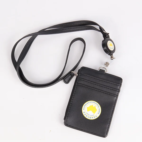 Black vertical card holder attached to a black lanyard and round retractable badge reel on a white background.