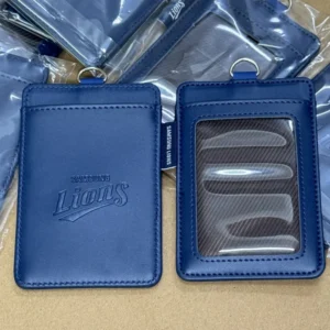 Two views of a blue vertical card holder showing an embossed Lions logo and a clear ID window.