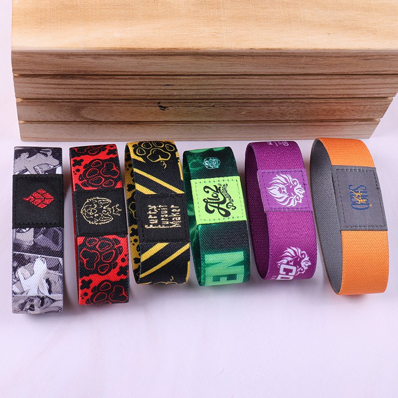 Custom elastic wristbands with colorful printed designs and branded labels
