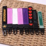 Close-up of custom woven jacquard key straps with logos and branded lettering