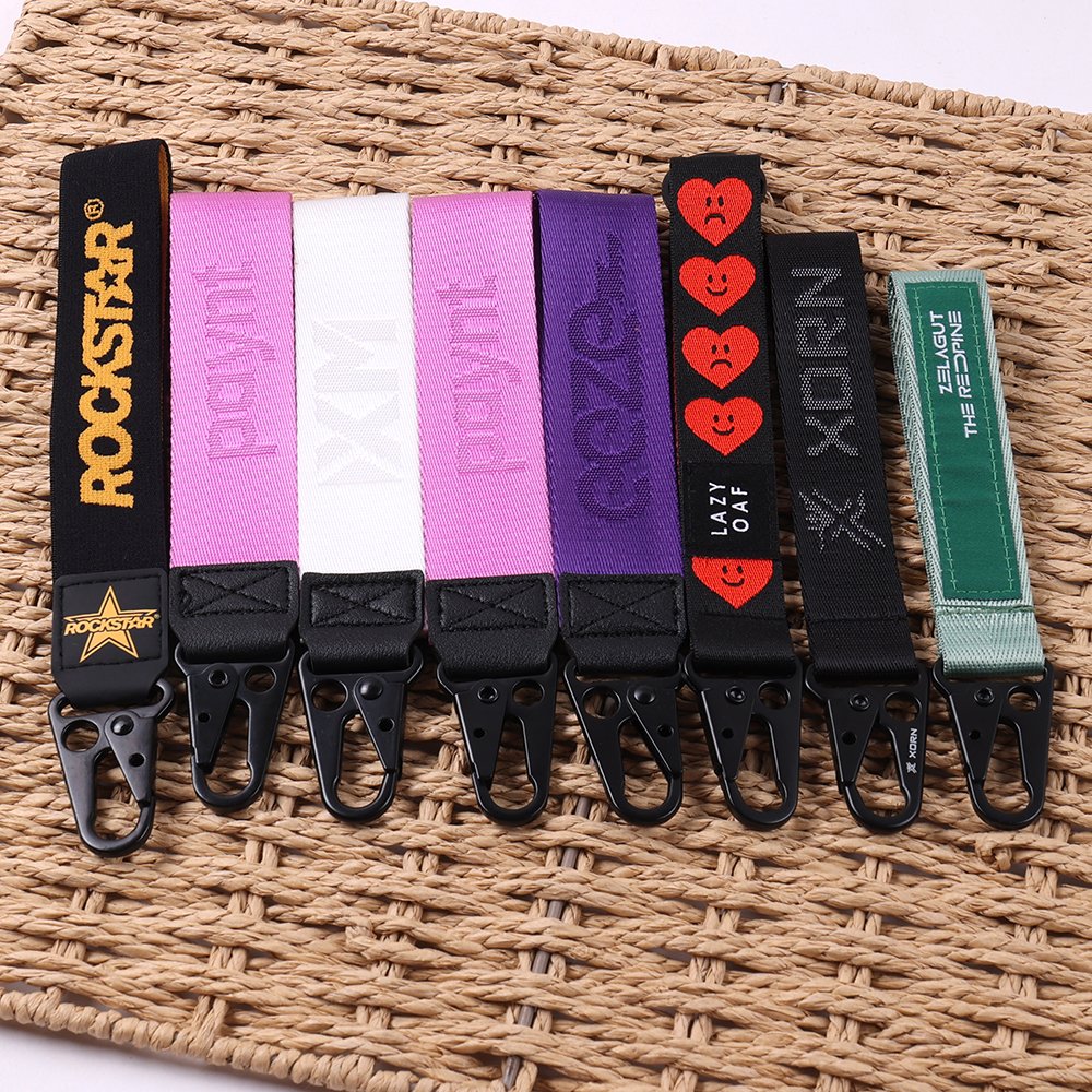 Close-up of custom woven jacquard key straps with logos and branded lettering