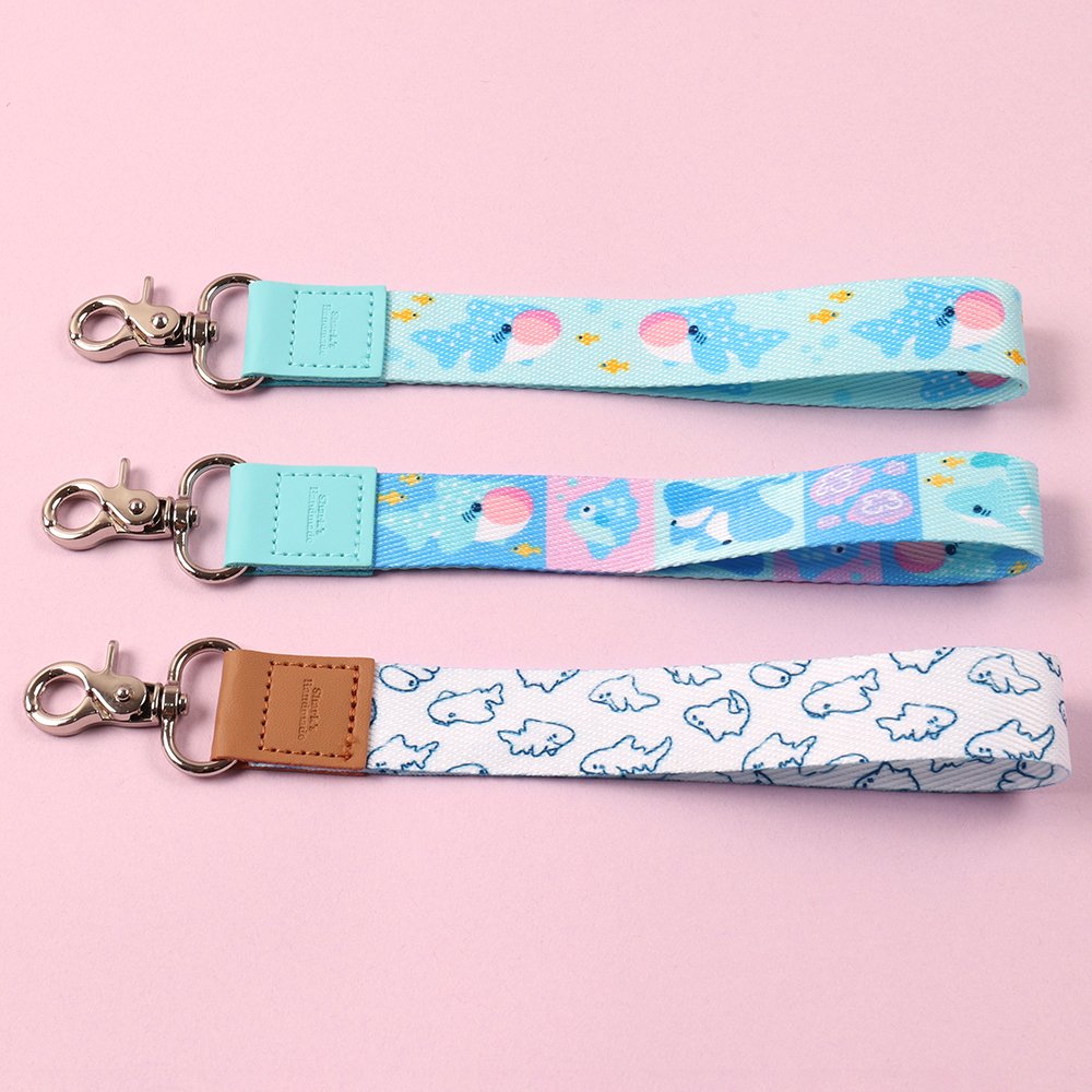 Printed polyester wristlet keychains with leather connectors and rose gold lobster clasps
