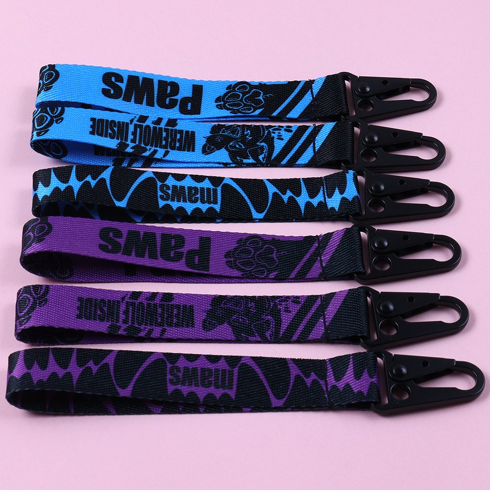 Blue and purple custom printed key straps with bold graphic logos and black snap hooks