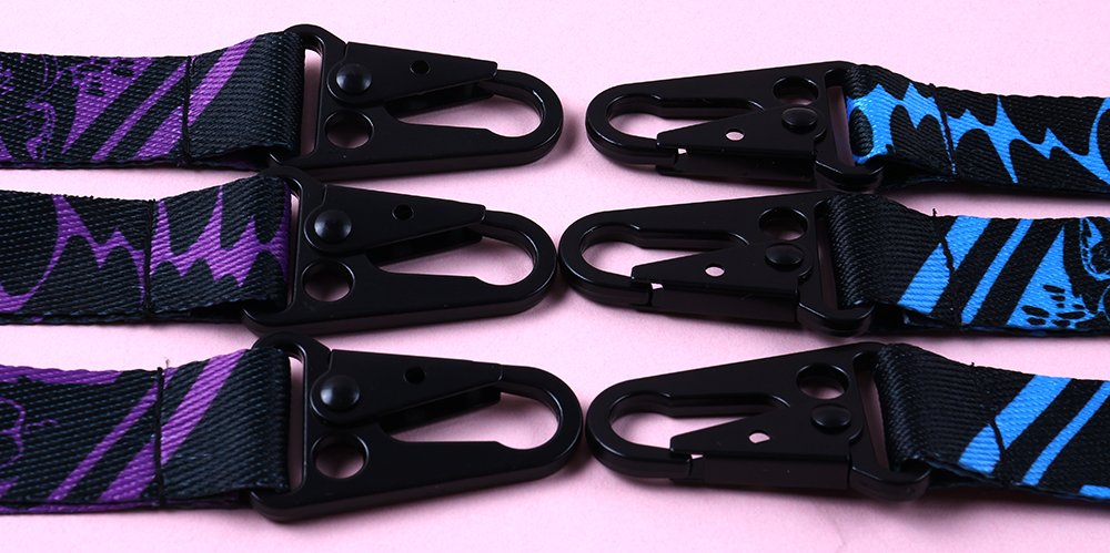 Close-up of custom key strap woven logos, reinforced stitching, clean edges and secure metal hardware