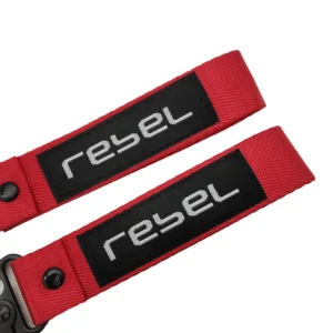 Two red motorcycle key tag lanyards with black rectangular sewn logo patches on a white background
