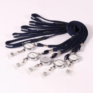 Black lanyards connected to round badge reels with metal key rings and clear straps