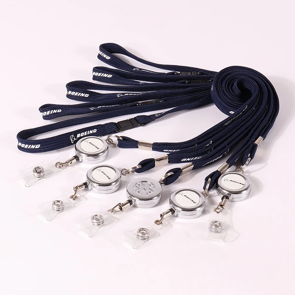Black lanyards connected to round badge reels with metal key rings and clear straps