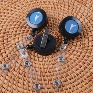 Black round badge reels with blue logo inserts, clear snap straps and metal belt clip