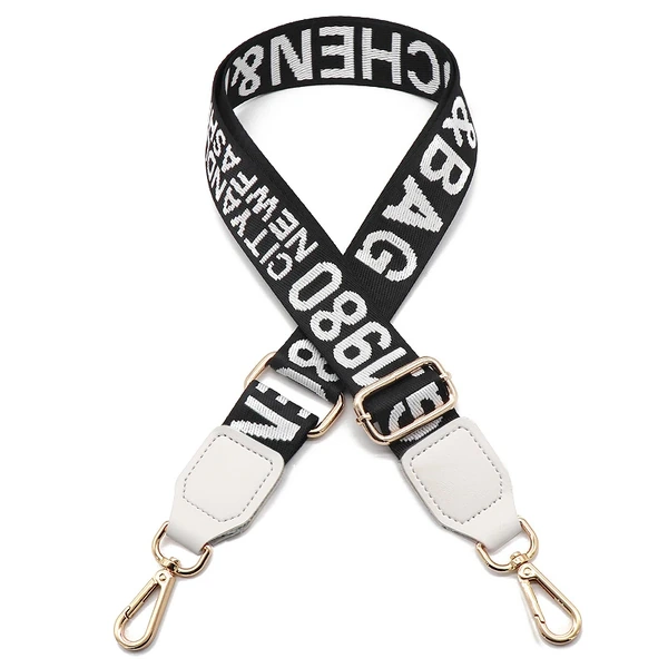Black adjustable shoulder strap with large white lettering, white end tabs and gold-colored clips