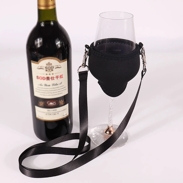 Black fabric holder supporting a stemmed wine glass beside a wine bottle, with a matching neck strap