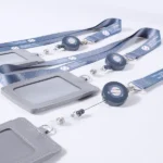Blue printed lanyards with round badge reels and gray ID card holders