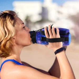 Woman drinking from a water bottle in a galaxy print carrier using the side hand strap