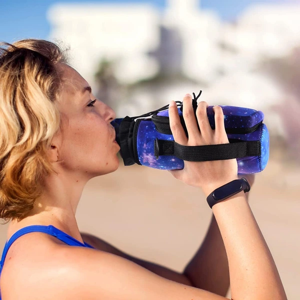 Woman drinking from a water bottle in a galaxy print carrier using the side hand strap