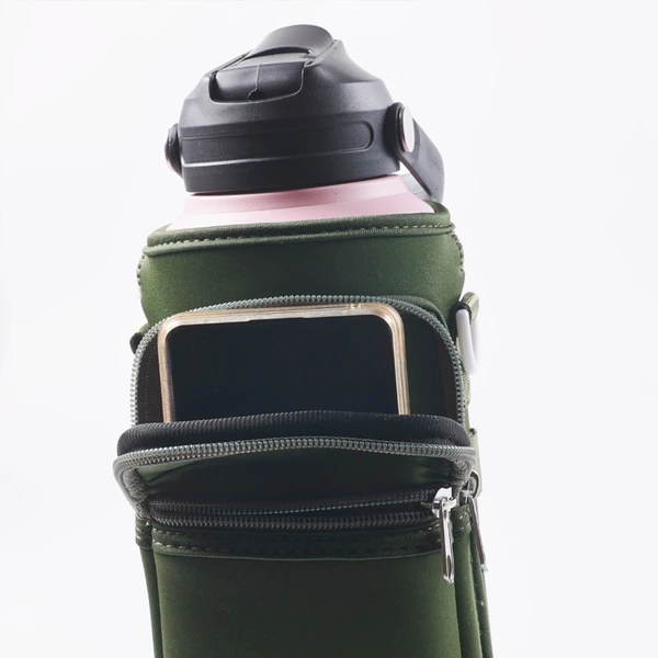 Close-up of a green carrier around a water bottle with a phone in the front pocket and zippered pouch below