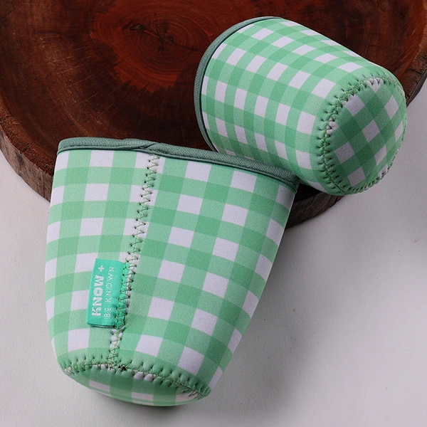Two green and white gingham cup sleeves showing stitched sides and circular bases