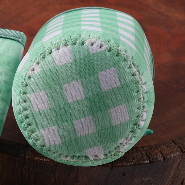 Close-up of a green gingham cup sleeve circular base with zigzag perimeter stitching