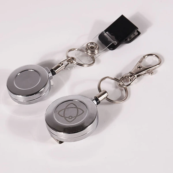 Silver round badge reels with key rings, swivel hook and black strap attachment