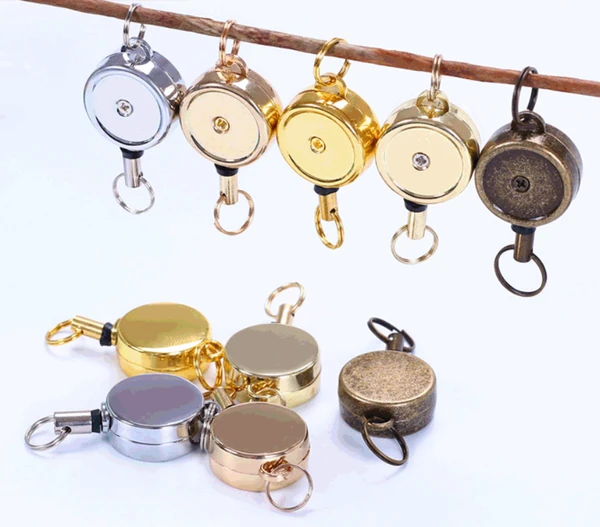 Round metal badge reels in silver, gold and antique finishes with key ring attachments