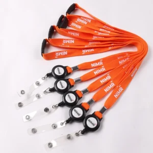 Orange printed lanyards connected to black round badge reels with clear snap straps