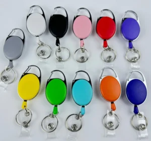 Oval badge reels in assorted colors with integrated carabiners and clear snap straps
