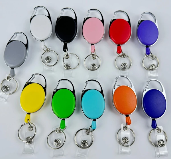 Oval badge reels in assorted colors with integrated carabiners and clear snap straps