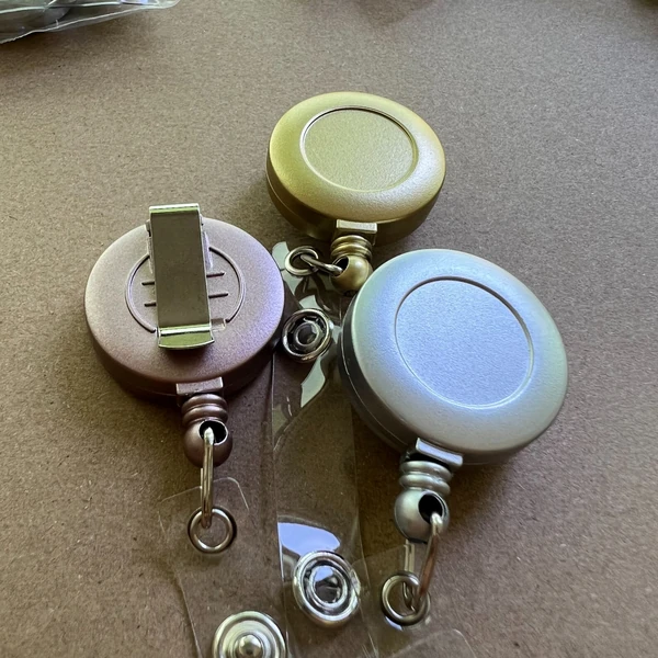 Pastel round metal badge reels with belt clips and swivel hooks
