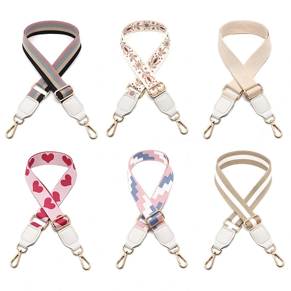 Six bag straps with striped, floral, solid, heart and geometric designs and gold-colored clips