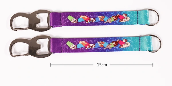 Two purple and turquoise printed short straps with metal bottle openers, rings and a 15 cm dimension annotation