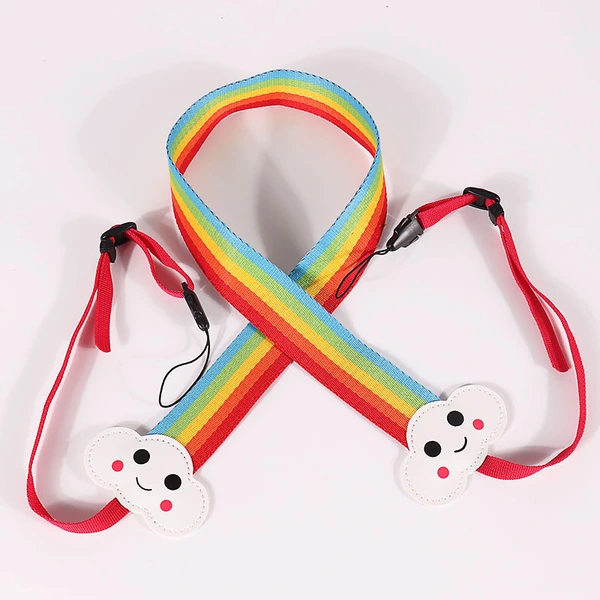 Rainbow striped camera strap with smiling white cloud-shaped details and red attachment webbing