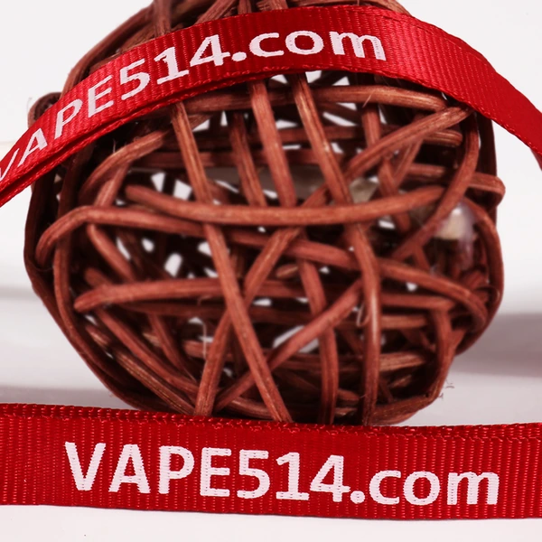 Red textured lanyard with white VAPE514.com lettering draped over a woven decorative ball