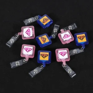Pink and blue square badge reels with printed logos and clear snap straps