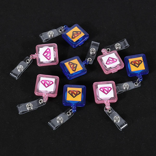 Pink and blue square badge reels with printed logos and clear snap straps