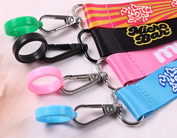 Green, black, pink and blue silicone holder rings connected to printed straps with metal swivel clips