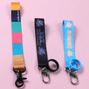 Three short straps with a multicolor block design, black lettering and blue cartoon print, fitted with clips and holder rings