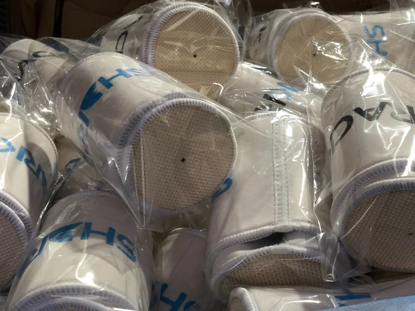 White printed cup sleeves individually packed in clear bags with circular bases visible