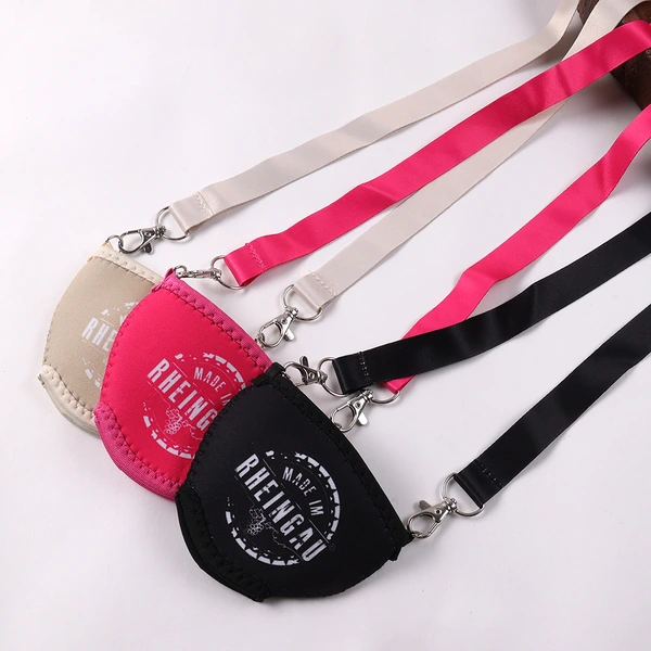 Beige, pink and black printed wine glass holders laid out with matching straps and metal clips