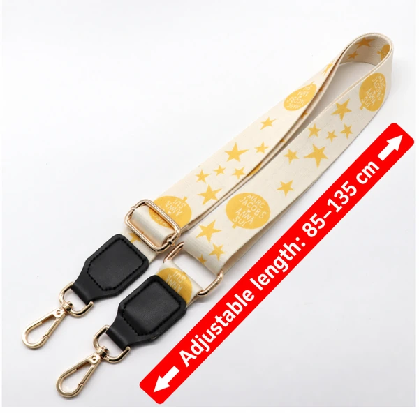 Yellow star-patterned strap with black end tabs, gold-colored clips and a red length annotation